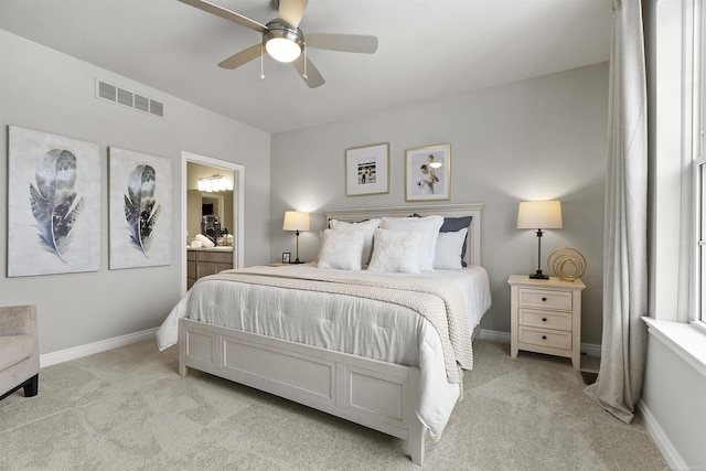 2215 Chase Dr Unit 102, Howell, MI 48855 - bedroom with light colored carpet, ensuite bathroom, baseboards, and a ceiling fan