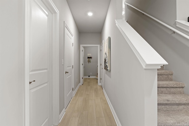 2215 Chase Dr Unit 102, Howell, MI 48855 - hall featuring light wood-style floors, stairway, baseboards, and recessed lighting