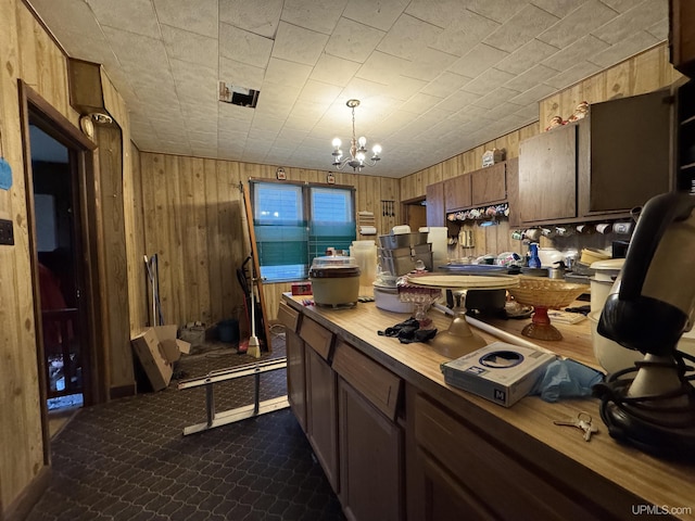 336 E Broad St, Lanse, MI 49946 - kitchen with wooden walls, a chandelier, and wood counters
