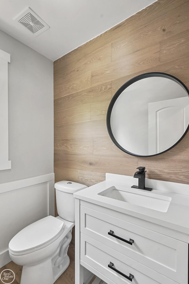 22007 Ridgeway St, Saint Clair Shores, MI 48080 - bathroom with toilet, wooden walls, and vanity