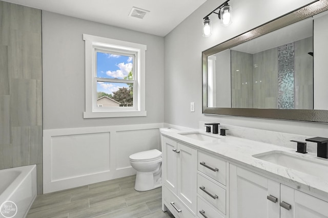 22007 Ridgeway St, Saint Clair Shores, MI 48080 - bathroom featuring double vanity, toilet, wainscoting, and wood finished floors