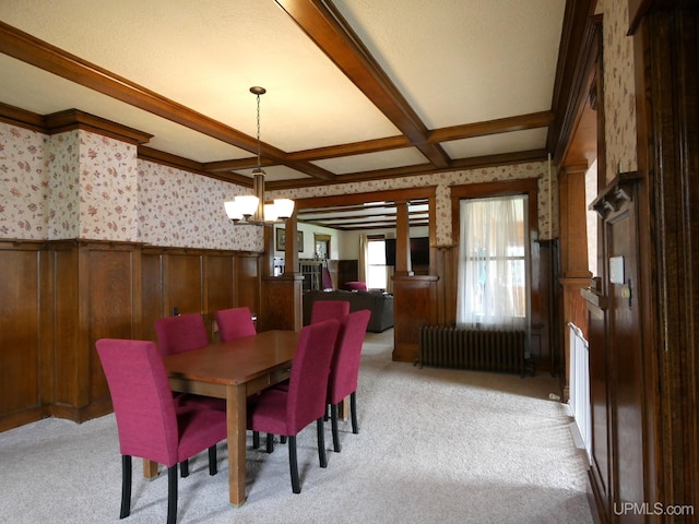 909 Quincy St, Hancock, MI 49930 - dining space with radiator, wallpapered walls, a wainscoted wall, a chandelier, and light colored carpet