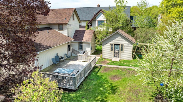 909 Quincy St, Hancock, MI 49930 - rear view of property with a deck, a lawn, a shingled roof, and a chimney