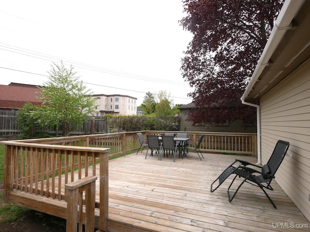 909 Quincy St, Hancock, MI 49930 - wooden terrace with outdoor dining area and a fenced backyard