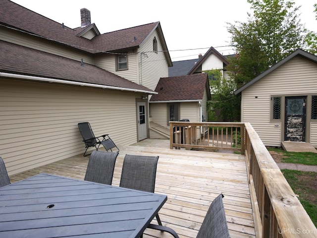 909 Quincy St, Hancock, MI 49930 - wooden deck featuring outdoor dining area