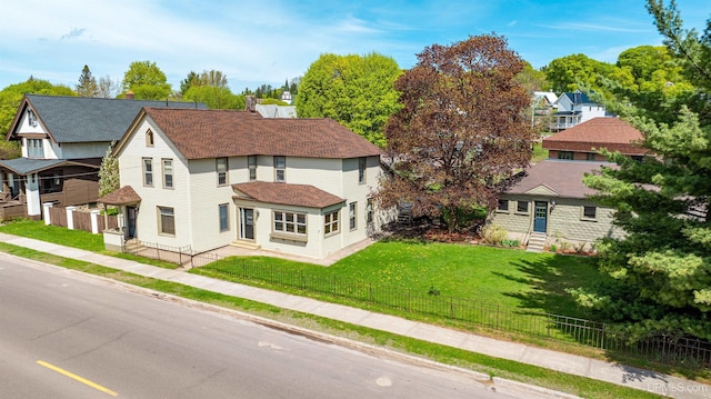 909 Quincy St, Hancock, MI 49930 - view of front facade featuring entry steps, roof with shingles, and a residential view