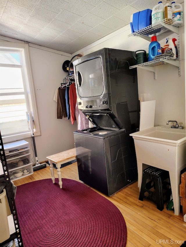 304 E Lincoln St, Negaunee, MI 49866 - laundry area with stacked washer / drying machine and light wood-type flooring