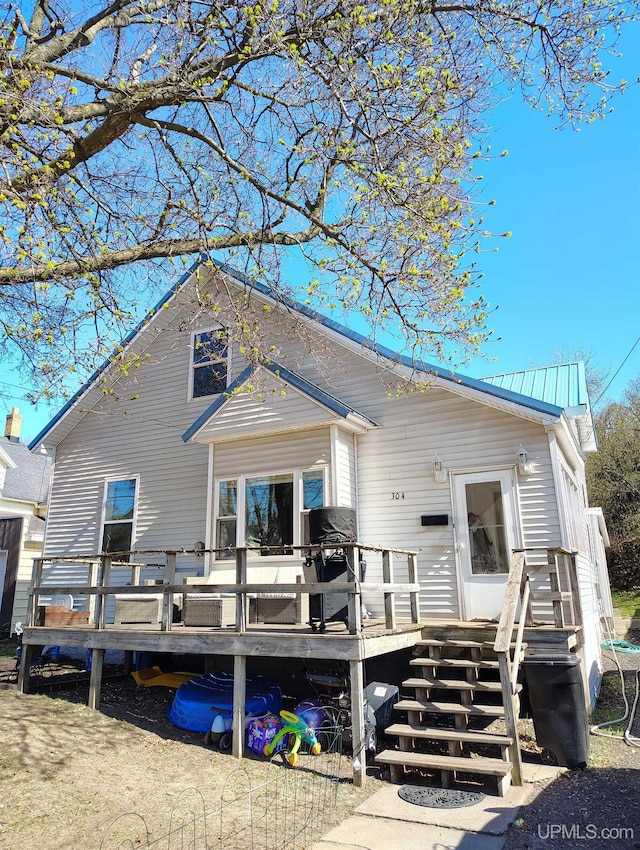 304 E Lincoln St, Negaunee, MI 49866 - back of property with a deck and metal roof