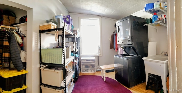 304 E Lincoln St, Negaunee, MI 49866 - laundry area featuring estacked washer and dryer and wood finished floors