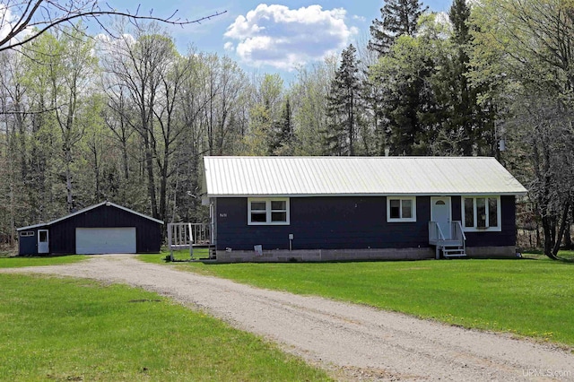 5631 County Road 550th Rd, Marquette, MI 49855 - ranch-style house featuring an outbuilding, a garage, metal roof, a front yard, and a forest view
