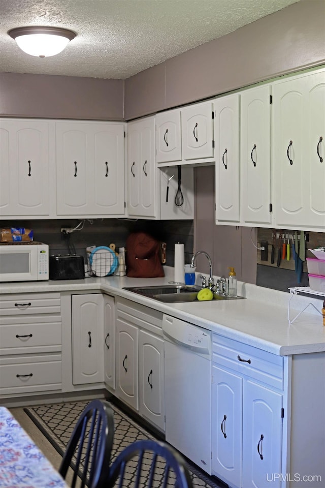 5631 County Road 550th Rd, Marquette, MI 49855 - kitchen with white appliances, a sink, a textured ceiling, white cabinets, and light countertops