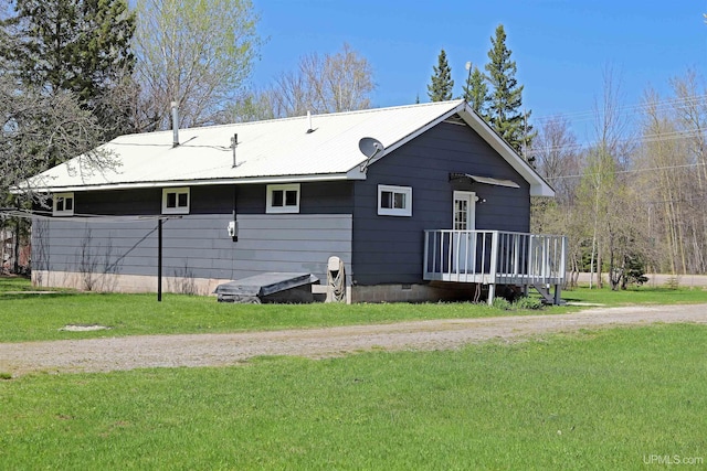 5631 County Road 550th Rd, Marquette, MI 49855 - back of house with a yard, crawl space, metal roof, and a deck