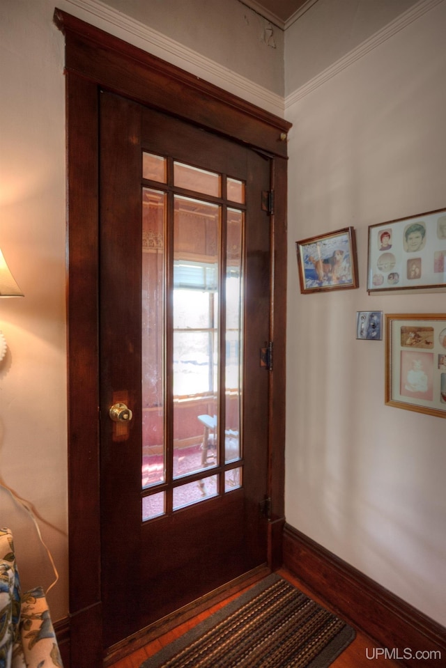 338 E Tamarack St, Ironwood, MI 49938 - entryway featuring baseboards, wood finished floors, and ornamental molding
