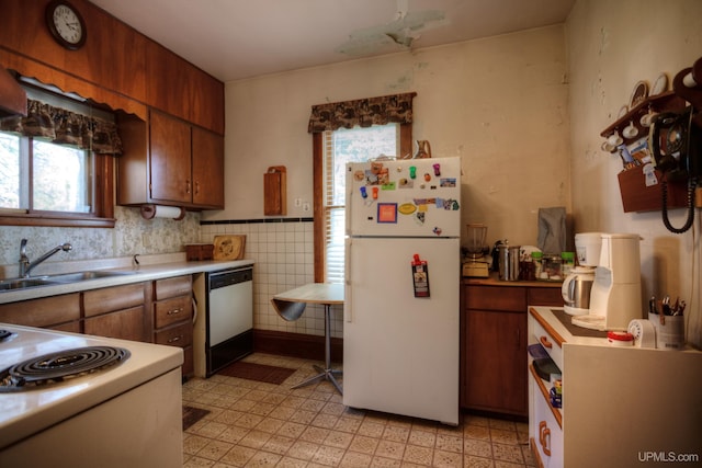 338 E Tamarack St, Ironwood, MI 49938 - kitchen featuring white appliances, plenty of natural light, a sink, and light countertops