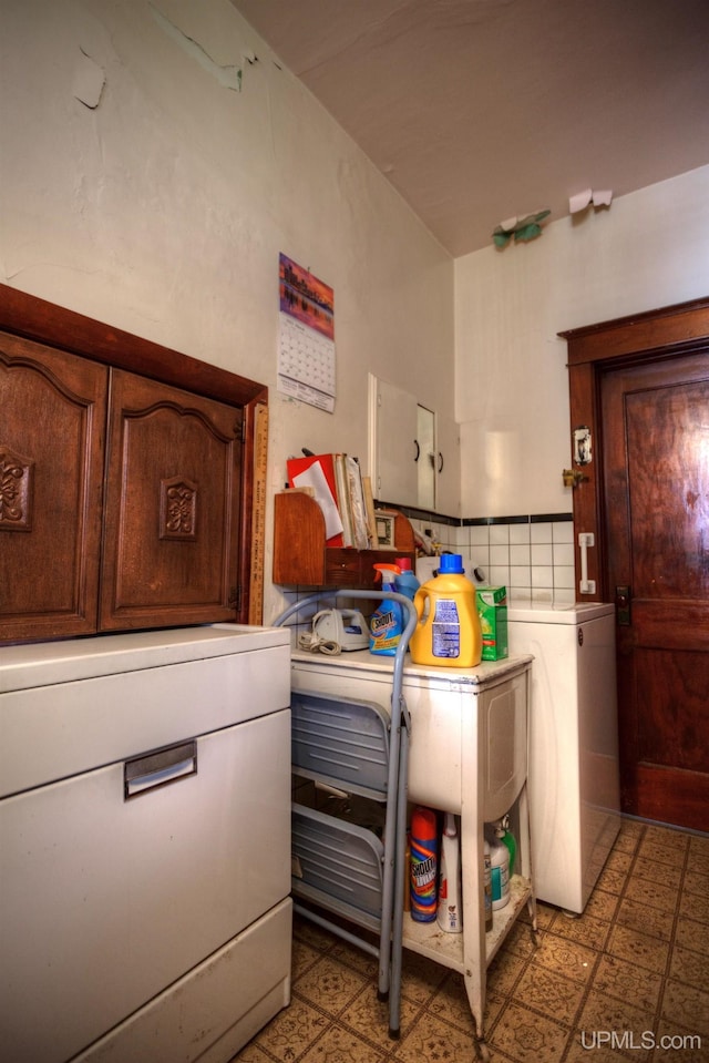 338 E Tamarack St, Ironwood, MI 49938 - laundry area featuring cabinet space, light floors, and washing machine and dryer