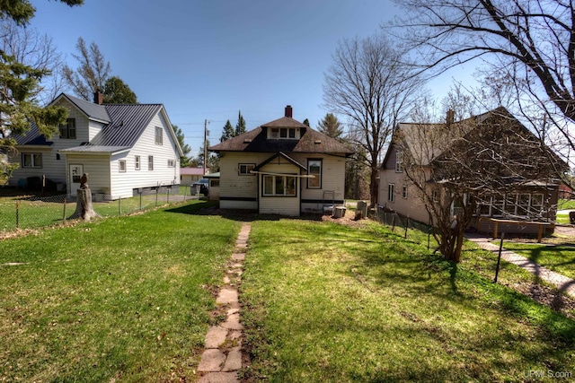 338 E Tamarack St, Ironwood, MI 49938 - back of property featuring a chimney