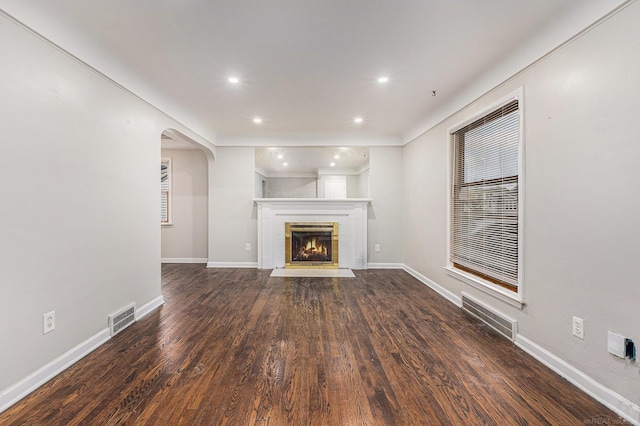 2678 Griffith Ave, Berkley, MI 48072 - unfurnished living room featuring arched walkways, recessed lighting, wood finished floors, baseboards, and a fireplace with flush hearth