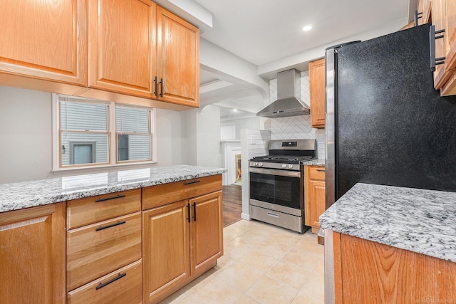 2678 Griffith Ave, Berkley, MI 48072 - kitchen with stainless steel appliances, wall chimney exhaust hood, backsplash, light stone counters, and light tile patterned floors