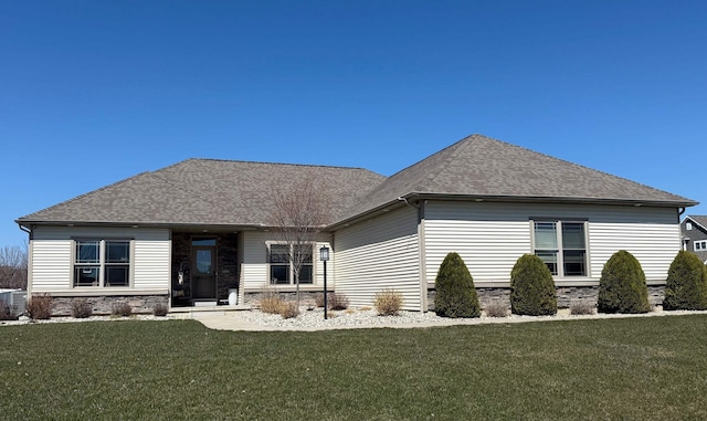 5266 Brook Hollow Ave, Bay City, MI 48706 - view of front facade featuring a front lawn, roof with shingles, and stone siding
