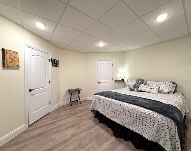 5266 Brook Hollow Ave, Bay City, MI 48706 - bedroom with light wood-type flooring, baseboards, a paneled ceiling, and recessed lighting
