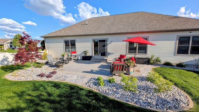 5266 Brook Hollow Ave, Bay City, MI 48706 - back of house featuring a yard, a patio, roof with shingles, and entry steps