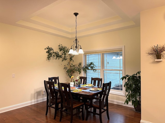 5266 Brook Hollow Ave, Bay City, MI 48706 - dining space with a tray ceiling, baseboards, dark wood finished floors, and a chandelier
