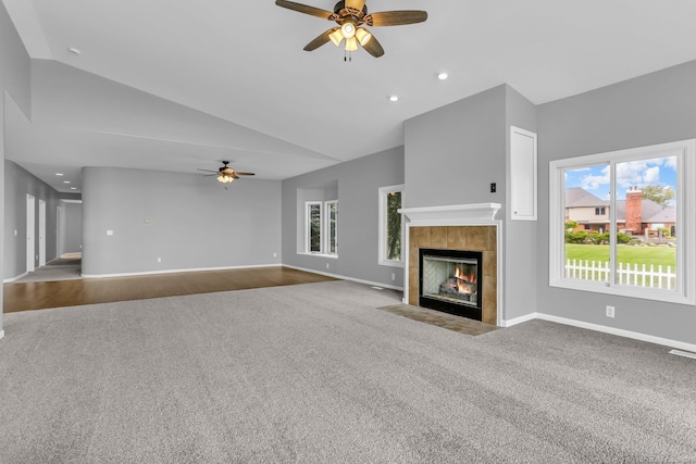 38340 Lakeshore Dr, Harrison Twp, MI 48045 - unfurnished living room with a ceiling fan, carpet, baseboards, a tile fireplace, and high vaulted ceiling