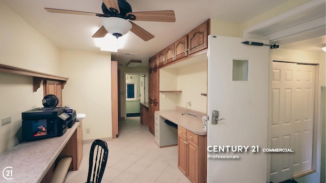 2884 Fort St, Lincoln Park, MI 48146 - kitchen featuring light countertops, ceiling fan, light tile patterned floors, and brown cabinetry