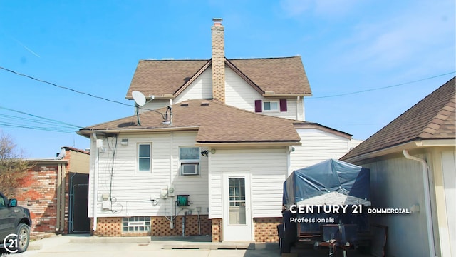 2884 Fort St, Lincoln Park, MI 48146 - rear view of property featuring a shingled roof and a chimney