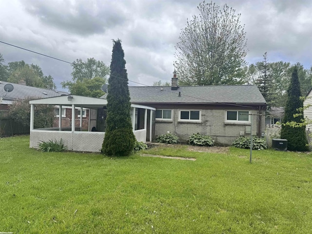 26100 Kathy St, Roseville, MI 48066 - back of house featuring brick siding, a sunroom, and a yard