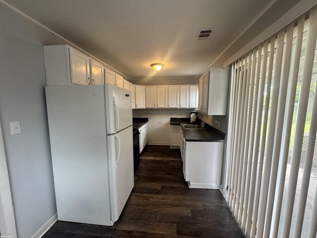 26100 Kathy St, Roseville, MI 48066 - kitchen with freestanding refrigerator, a sink, dark countertops, dark wood-style flooring, and white cabinets