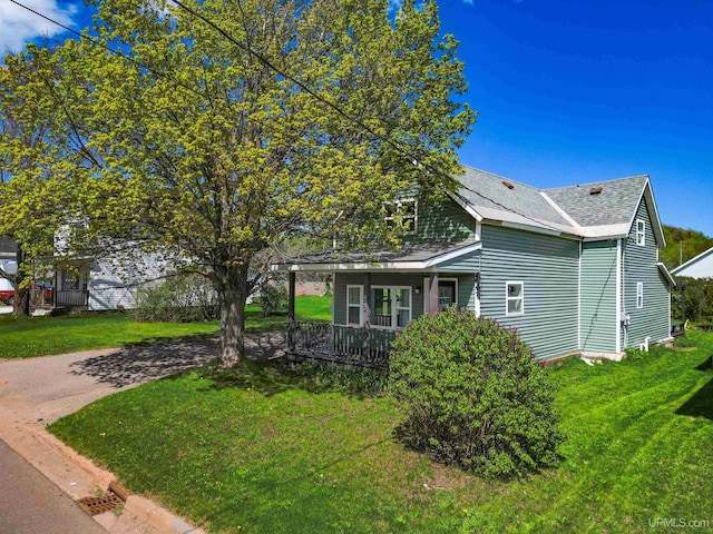 422 Washington St, Ishpeming, MI 49849 - view of side of property featuring roof with shingles and a lawn