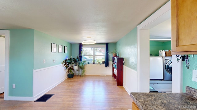 422 Washington St, Ishpeming, MI 49849 - hallway with light wood-style floors and a wainscoted wall