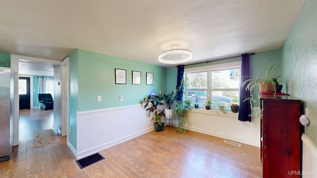 422 Washington St, Ishpeming, MI 49849 - interior space featuring wood finished floors, healthy amount of natural light, and a textured ceiling