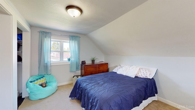 422 Washington St, Ishpeming, MI 49849 - bedroom featuring carpet, lofted ceiling, and baseboards