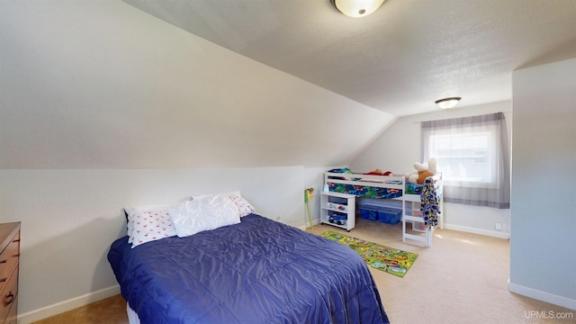 422 Washington St, Ishpeming, MI 49849 - bedroom featuring vaulted ceiling, baseboards, carpet, and a textured ceiling
