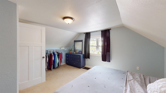 422 Washington St, Ishpeming, MI 49849 - carpeted bedroom with vaulted ceiling, a textured ceiling, and a closet
