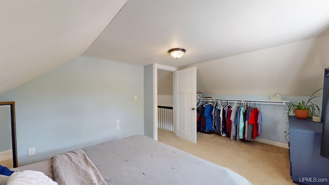 422 Washington St, Ishpeming, MI 49849 - bedroom with lofted ceiling, light carpet, and a closet