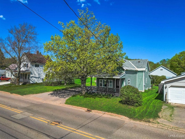 422 Washington St, Ishpeming, MI 49849 - view of front of home with a porch, a front lawn, and a garage