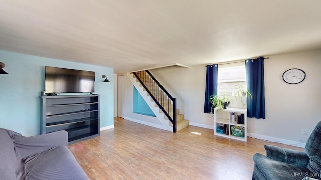 422 Washington St, Ishpeming, MI 49849 - living area with stairs, wood finished floors, and baseboards