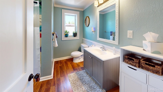 422 Washington St, Ishpeming, MI 49849 - full bathroom with vanity, wood finished floors, toilet, and baseboards