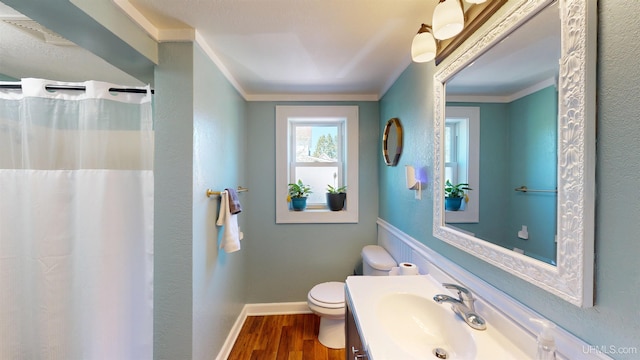 422 Washington St, Ishpeming, MI 49849 - full bath with toilet, wood finished floors, vanity, baseboards, and crown molding
