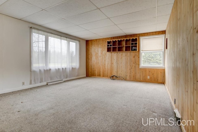 1782 H Rd, Bark River, MI 49807 - unfurnished room featuring wood walls, carpet floors, baseboards, and a paneled ceiling