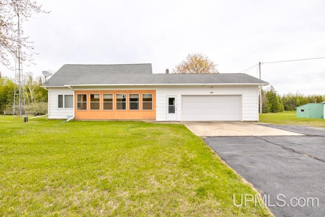 1782 H Rd, Bark River, MI 49807 - view of front of property with asphalt driveway, an attached garage, and a front lawn