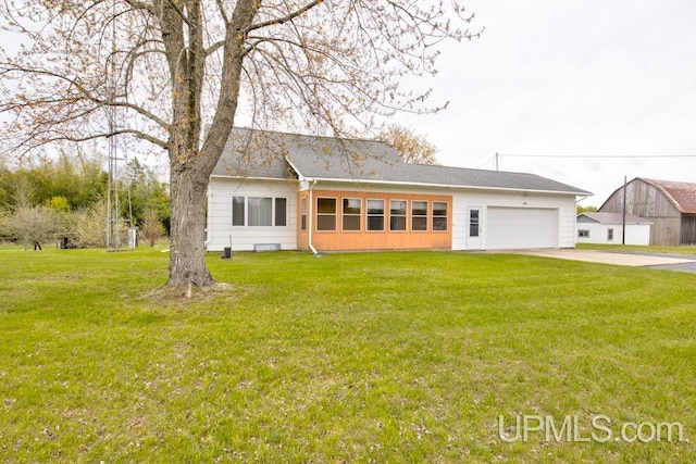 1782 H Rd, Bark River, MI 49807 - view of front of home featuring an attached garage, a front lawn, and concrete driveway