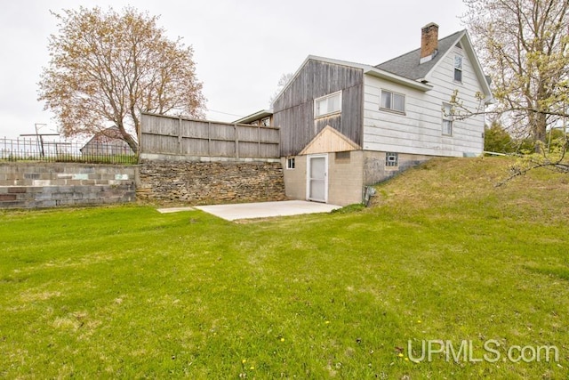 1782 H Rd, Bark River, MI 49807 - back of house featuring a patio and a chimney