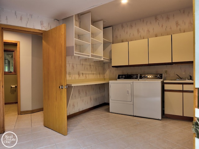 966 Pine Needle Trl, Oakland Twp, MI 48306 - laundry area featuring cabinet space, wallpapered walls, washer and clothes dryer, light tile patterned floors, and baseboards