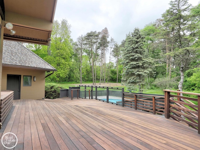 966 Pine Needle Trl, Oakland Twp, MI 48306 - wooden terrace featuring view of wooded area and an outdoor pool