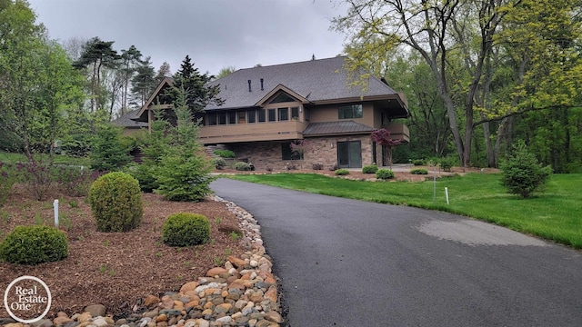 966 Pine Needle Trl, Oakland Twp, MI 48306 - view of front facade with asphalt driveway, a front lawn, and a sunroom