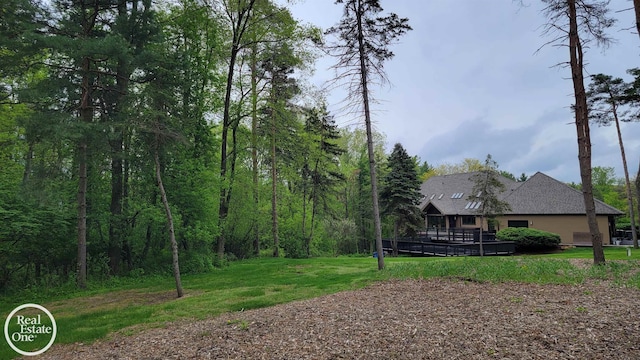 966 Pine Needle Trl, Oakland Twp, MI 48306 - view of green lawn with a deck